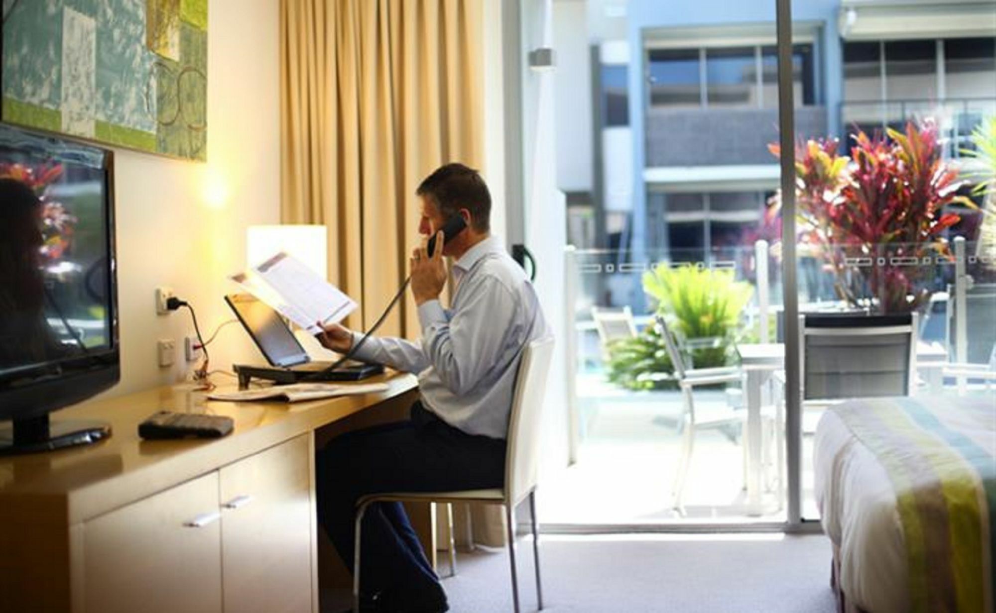 Ramada By Wyndham Hervey Bay Bagian luar foto A business traveller working in a hotel room